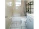 Bathroom featuring a shower-tub combination, updated vanity, and neutral tile flooring at 4705 Murray Hill Dr, Tampa, FL 33615