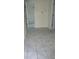 Bright bedroom with white tile floors, an open doorway, and neutral walls at 4705 Murray Hill Dr, Tampa, FL 33615