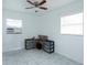 Bright bedroom features tile floors, ceiling fan, and large windows at 4705 Murray Hill Dr, Tampa, FL 33615