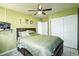Spacious bedroom with full-size bed, ceiling fan, closet, and neutral decor at 4705 Murray Hill Dr, Tampa, FL 33615