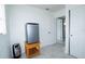 White room with stainless steel mini fridge, tile floors, and open doorway at 4705 Murray Hill Dr, Tampa, FL 33615