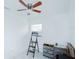 White bedroom with ceiling fan and tile flooring with a ladder at 4705 Murray Hill Dr, Tampa, FL 33615