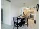 Dining area with tile floors opening to the kitchen with stainless appliances at 4705 Murray Hill Dr, Tampa, FL 33615