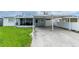 Exterior of a single story home with a carport and screened in patio at 4705 Murray Hill Dr, Tampa, FL 33615