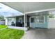 View of the screened in porch and carport from the backyard at 4705 Murray Hill Dr, Tampa, FL 33615