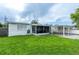 Single story home with a cozy enclosed patio and a convenient carport at 4705 Murray Hill Dr, Tampa, FL 33615