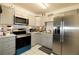 Well-lit kitchen with stainless steel refrigerator and modern appliances at 4705 Murray Hill Dr, Tampa, FL 33615