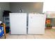 Close-up of the laundry machines in a room with white ceramic floors and pale gray walls at 4705 Murray Hill Dr, Tampa, FL 33615