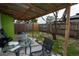 Backyard patio with a glass top table, seating, and a view of the fenced-in backyard at 4705 Murray Hill Dr, Tampa, FL 33615