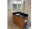 Bathroom vanity featuring dark granite countertops and a vessel sink at 500 Belcher S Rd # 109, Largo, FL 33771