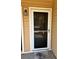Inviting condo front door with storm door and visible house number at 500 Belcher S Rd # 109, Largo, FL 33771