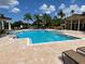 Resort-style pool with ample lounge seating and lush tropical landscaping at 500 Belcher S Rd # 109, Largo, FL 33771