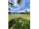 Scenic putting green by the lake, perfect for relaxation and leisurely golf practice under a sunny sky at 500 Belcher S Rd # 109, Largo, FL 33771
