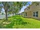 Expansive grassy backyard featuring mature trees and ample space for outdoor activities at 5015 58Th E Ter, Bradenton, FL 34203