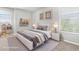 Tastefully furnished bedroom featuring a white platform bed, decorative shelves, and framed wall art at 5015 58Th E Ter, Bradenton, FL 34203