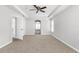 Spacious carpeted bedroom with a ceiling fan and tray ceiling detail at 5015 58Th E Ter, Bradenton, FL 34203