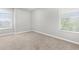 A bright bedroom features neutral carpet and large windows, perfect for personalization at 5015 58Th E Ter, Bradenton, FL 34203