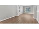 Bright, empty room with light gray walls and pristine wood laminate flooring at 5015 58Th E Ter, Bradenton, FL 34203