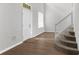 Bright entryway featuring wood floors, staircase with white railing, and natural light from the window at 5015 58Th E Ter, Bradenton, FL 34203