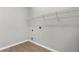Empty laundry room with wood floors and wire shelf perfect for organizing your laundry essentials at 5015 58Th E Ter, Bradenton, FL 34203