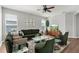 A modern living room featuring a comfy green couch, lots of light and a soft rug at 5015 58Th E Ter, Bradenton, FL 34203