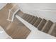 Carpeted staircase with white banister railing, showcasing a safe and stylish transition between floors at 5015 58Th E Ter, Bradenton, FL 34203