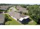 Aerial view of a home with screened in patio in a suburban neighborhood with mature trees and landscaping at 5131 Gato Del Sol Cir, Wesley Chapel, FL 33544