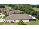 Aerial view of the house showcasing its well-maintained backyard, screened patio, and beautiful neighborhood pond at 5131 Gato Del Sol Cir, Wesley Chapel, FL 33544