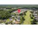 Overhead shot of community with golf course, ponds, and homes surrounded by beautiful green landscape at 5131 Gato Del Sol Cir, Wesley Chapel, FL 33544