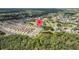 Scenic aerial view of a residential community nestled among lush trees, a golf course and a pond at 5131 Gato Del Sol Cir, Wesley Chapel, FL 33544