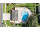 Aerial shot of a sparkling community pool with ample lounge seating and a convenient pool house at 5131 Gato Del Sol Cir, Wesley Chapel, FL 33544