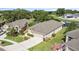 Aerial view of home showcasing the landscaped yard and backyard pond views in a beautiful neighborhood setting at 5131 Gato Del Sol Cir, Wesley Chapel, FL 33544