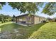 Exterior view of the home with a covered patio and well-maintained lawn at 5131 Gato Del Sol Cir, Wesley Chapel, FL 33544