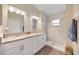 Bathroom with dual sinks, granite countertops and a walk-in shower at 5131 Gato Del Sol Cir, Wesley Chapel, FL 33544
