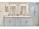 Bathroom features double vanity with granite counters, shower and vanity lighting at 5131 Gato Del Sol Cir, Wesley Chapel, FL 33544