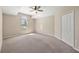 Spacious bedroom with a ceiling fan, large window, and closet at 5131 Gato Del Sol Cir, Wesley Chapel, FL 33544