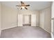 Spacious bedroom boasts double doors, neutral walls, and plush carpeting at 5131 Gato Del Sol Cir, Wesley Chapel, FL 33544