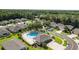 Aerial view of a well-maintained community pool, cabana, and surrounding green space and residences at 5131 Gato Del Sol Cir, Wesley Chapel, FL 33544
