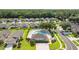 Aerial view showcases community pool, a green space and houses near the beautiful neighborhood at 5131 Gato Del Sol Cir, Wesley Chapel, FL 33544