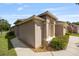 Attractive single-story home with a stucco exterior, arched entry, and well-kept landscaping at 5131 Gato Del Sol Cir, Wesley Chapel, FL 33544