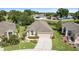 Charming home exterior with landscaped front yard, inviting curb appeal, and an attached two-car garage at 5131 Gato Del Sol Cir, Wesley Chapel, FL 33544