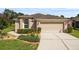 Charming single-story home featuring a two-car garage, manicured lawn, and well-maintained landscaping at 5131 Gato Del Sol Cir, Wesley Chapel, FL 33544