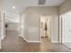 Bright hallway with wood-look flooring leading to a full bathroom and an open living area at 5131 Gato Del Sol Cir, Wesley Chapel, FL 33544