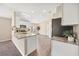 Modern kitchen with stainless steel appliances, granite countertops, and wood-look flooring at 5131 Gato Del Sol Cir, Wesley Chapel, FL 33544