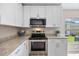 Well-equipped kitchen with stainless steel appliances and white cabinets at 5131 Gato Del Sol Cir, Wesley Chapel, FL 33544