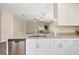 Modern kitchen featuring stainless steel appliances and granite countertops opening into the living area at 5131 Gato Del Sol Cir, Wesley Chapel, FL 33544