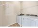 Laundry room includes new washer and dryer, with storage space at 5131 Gato Del Sol Cir, Wesley Chapel, FL 33544