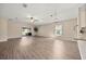 Spacious living room featuring wood-look floors, ceiling fan, sliding glass doors and view to the backyard at 5131 Gato Del Sol Cir, Wesley Chapel, FL 33544
