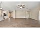 Open living room with ceiling fan and view of the kitchen and entryway at 5131 Gato Del Sol Cir, Wesley Chapel, FL 33544