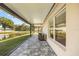 Relax on this covered patio that overlooks the lake and backyard at 5131 Gato Del Sol Cir, Wesley Chapel, FL 33544